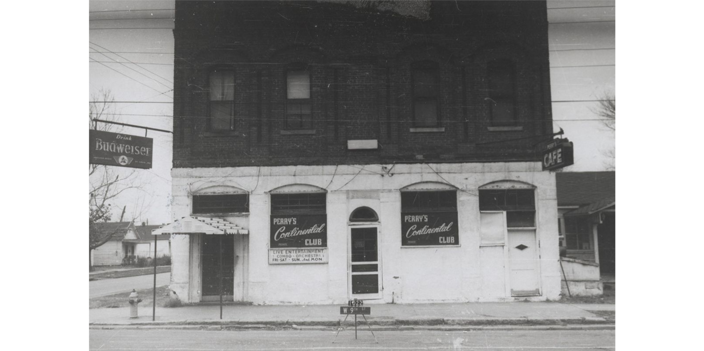 A multi-storied building with signs in the windows which read: "Perry's Continental Club."