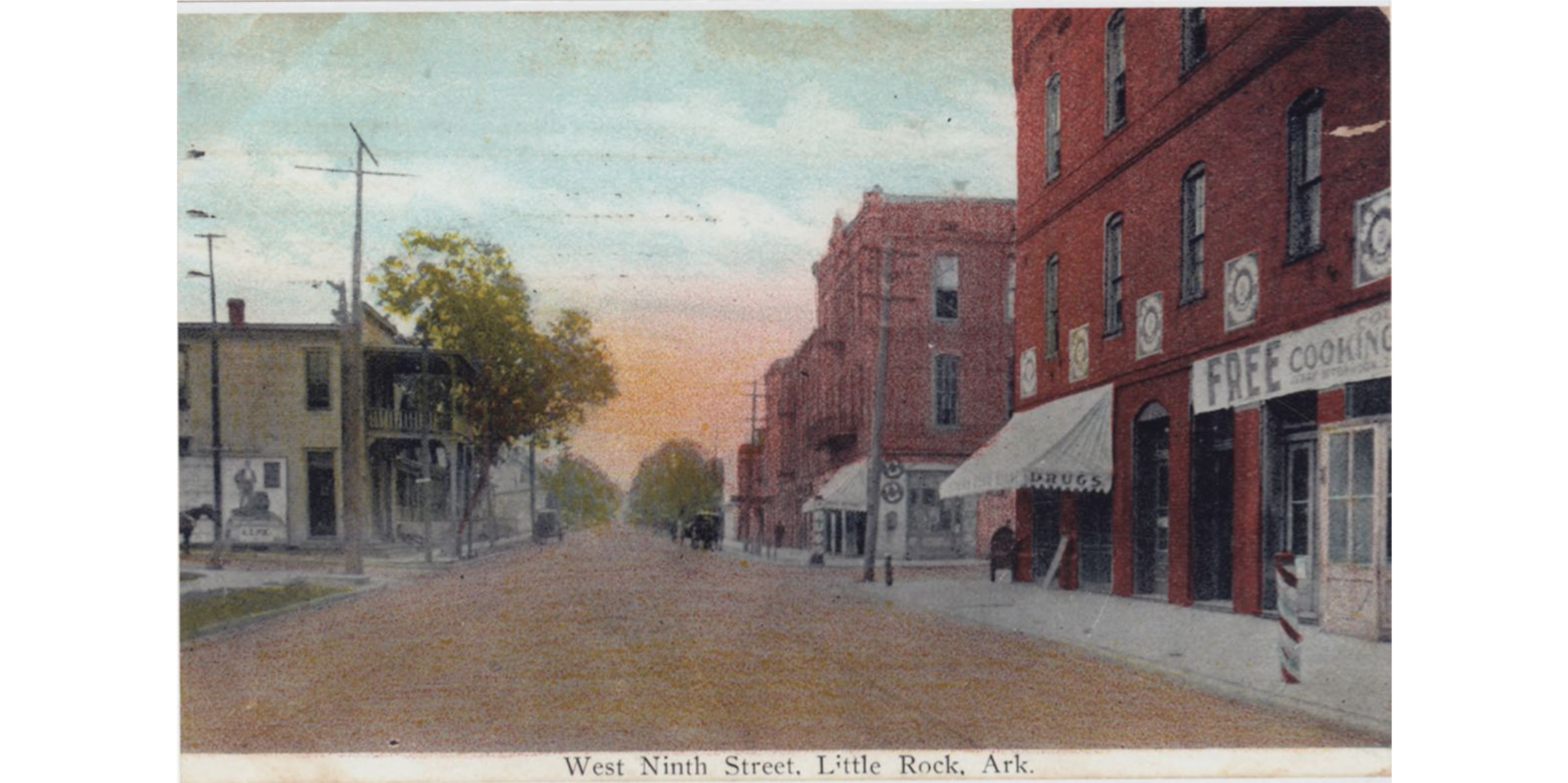 A view of a West Ninth Street in Little Rock in the early 1900s, with red brick buildings, cars in distance, and possibly some persons. A storefront says "drugs."