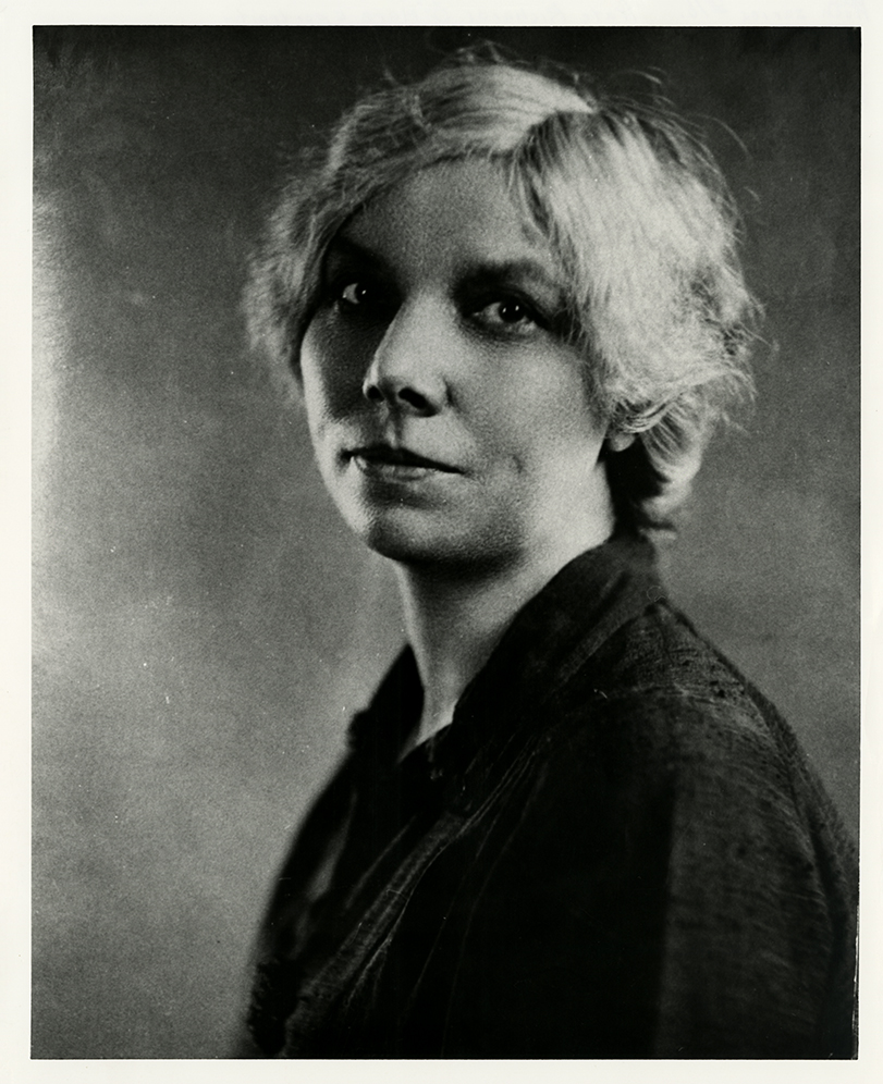 A black and white headshot portrait of a woman.