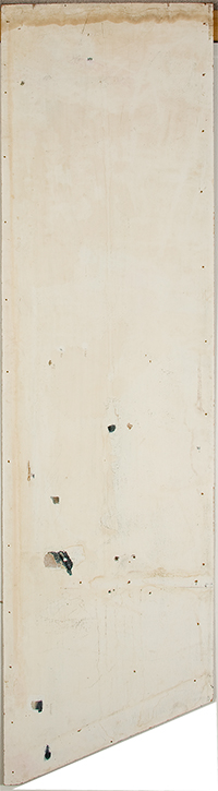 A panel covered in white paint. There is a stain across the top of the panel and some splatters of black paint toward the bottom.
