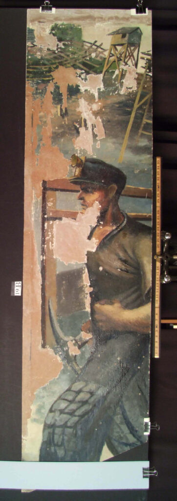 A mural scene of a coal miner walking with a pick-axe in one hand and his other hand clenched into a fist. This image was revealed after the white paint was removed during conservation efforts. There is substantial loss of the original paint.