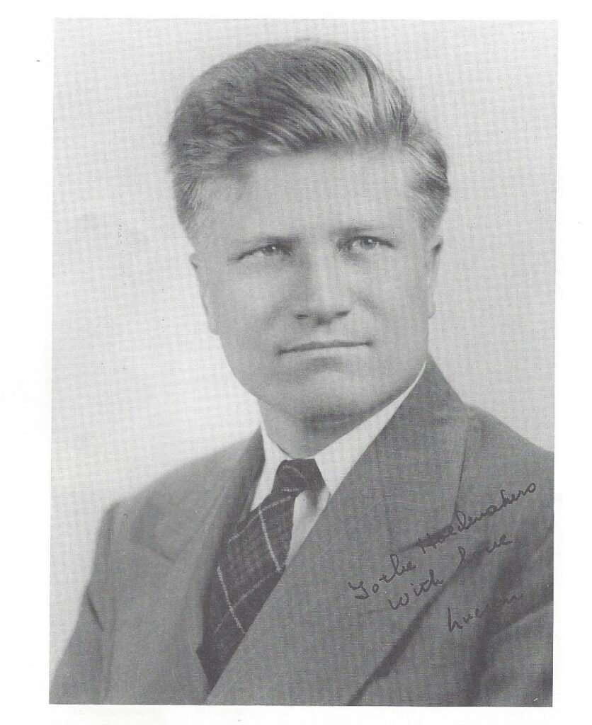 A portrait of a man in a suit and tie.